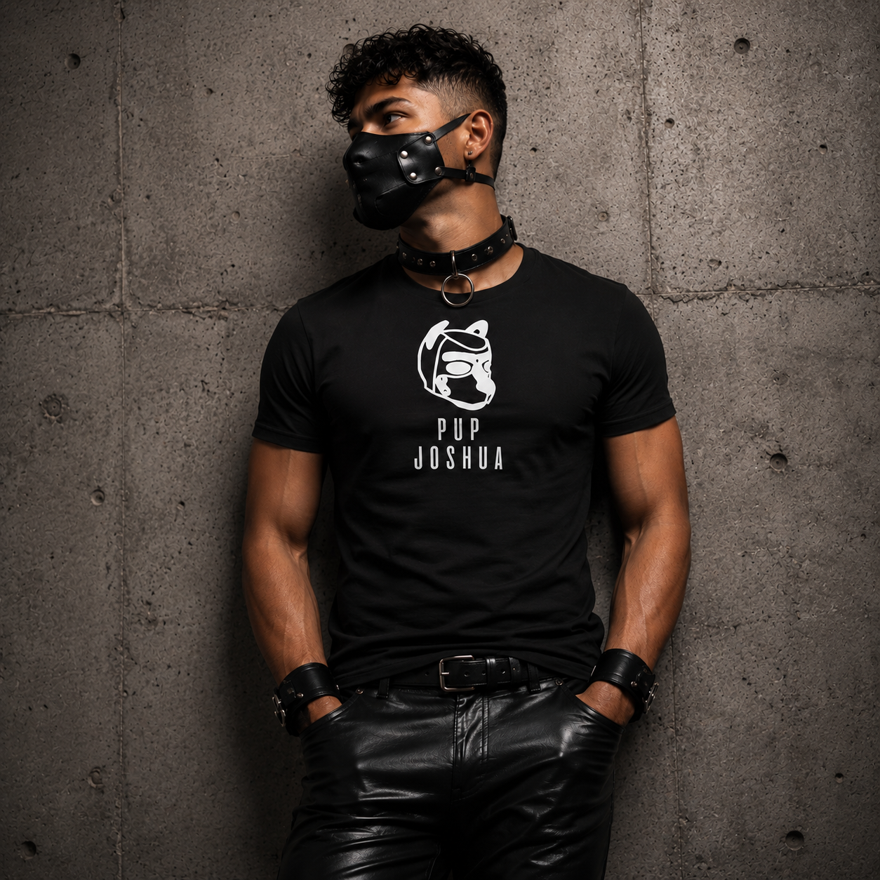 Black personalised pup hood t-shirt worn with leather pup hood — side-profile pup hood emblem with custom pup name on left chest, everyday pup identity wear by FETBOMB.