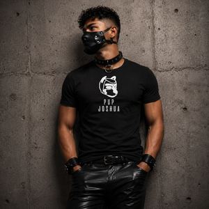 Black personalised pup hood t-shirt worn with leather pup hood — side-profile pup hood emblem with custom pup name on left chest, everyday pup identity wear by FETBOMB.