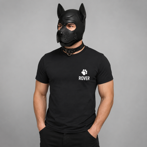 Black personalised pup play t-shirt worn with a neoprene pup hood and collar — paw print design with custom pup name on left chest, from FETBOMB.