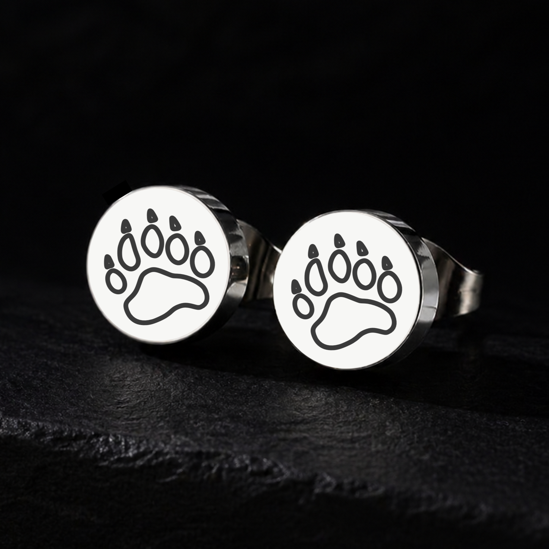 Silver bear paw stud earrings on a black background, 10mm or 12mm stainless steel bear pride jewellery for the gay bear and cub community from FETBOMB.