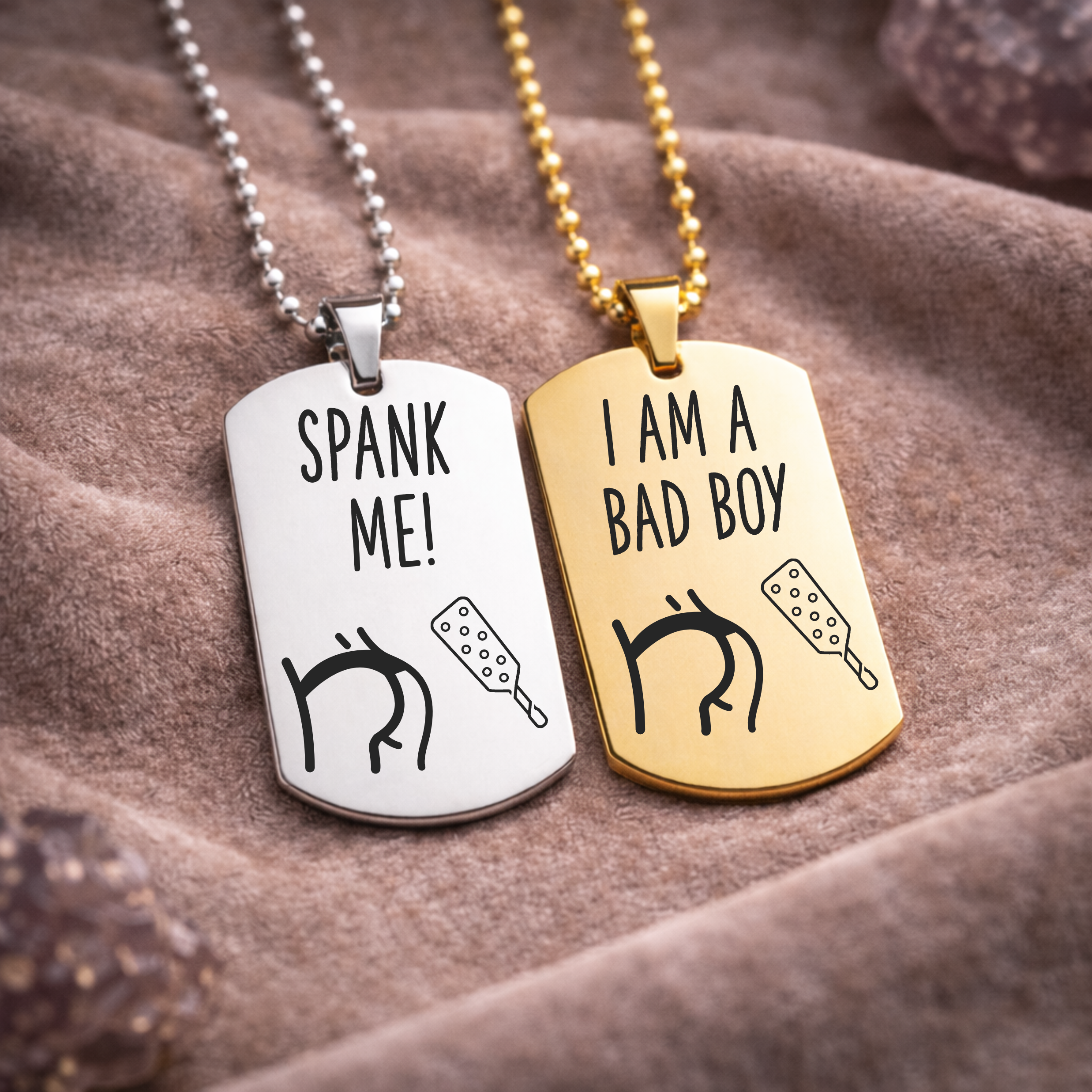 Spank Me and I Am a Bad Boy engraved BDSM dog tag necklaces in silver and gold stainless steel on fabric background
